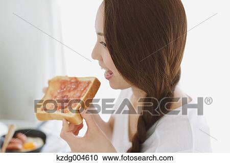 Young attractive Japanese woman having breakfast at home View Large Photo Image Stock Image - Young attractive Japanese woman having breakfast at home. Fotosearch