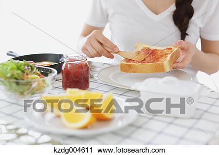 Young attractive Japanese woman having breakfast at home View Large Photo Image Stock Image - Young attractive Japanese woman having breakfast at home. Fotosearch