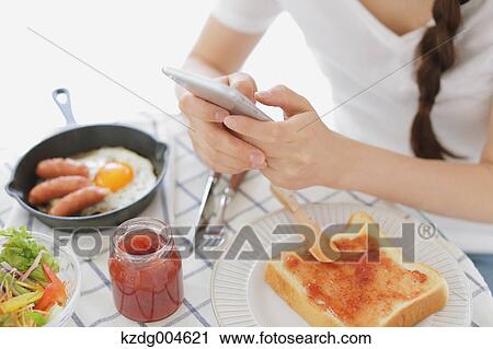 Young attractive Japanese woman having breakfast at home View Large Photo Image Stock Image - Young attractive Japanese woman having breakfast at home. Fotosearch
