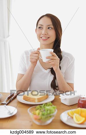 Young attractive Japanese woman having breakfast at home View Large Photo Image Stock Photo - Young attractive Japanese woman having breakfast at home. Fotosearch