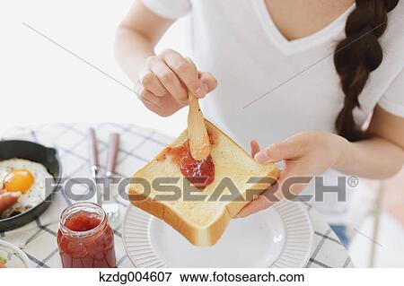 Young attractive Japanese woman having breakfast at home View Large Photo Image Stock Photo - Young attractive Japanese woman having breakfast at home. Fotosearch