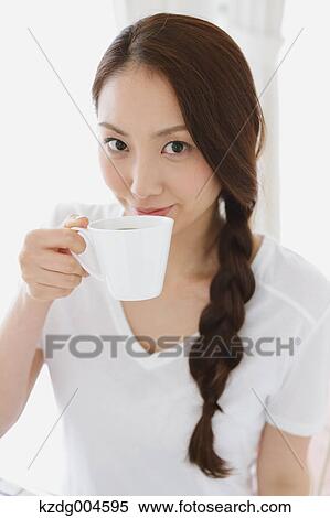 Young attractive Japanese woman having cofee at home View Large Photo Image Stock Photography - Young attractive Japanese woman having cofee at home. Fotosearch