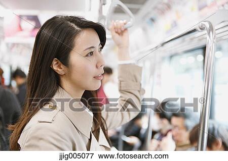 Young attractive Japanese woman on the train View Large Photo Image Stock Photo - Young attractive Japanese woman on the train. Fotosearch