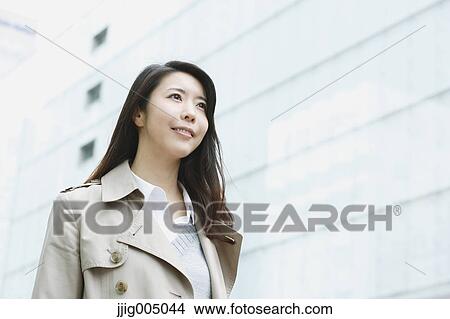 Picture - Young attractive Japanese woman downtown Tokyo. Fotosearch