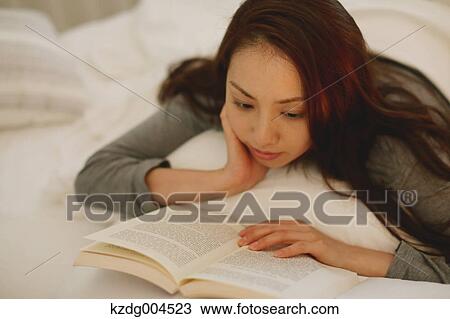 Young attractive Japanese woman reading in bed View Large Photo Image Stock Image - Young attractive Japanese woman reading in bed. Fotosearch