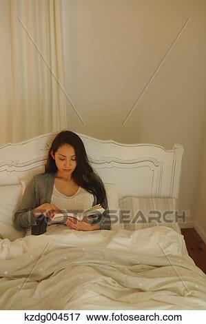 Young attractive Japanese woman reading in bed View Large Photo Image Stock Photo - Young attractive Japanese woman reading in bed. Fotosearch