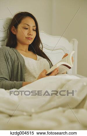 Young attractive Japanese woman reading in bed View Large Photo Image Stock Photography - Young attractive Japanese woman reading in bed. Fotosearch