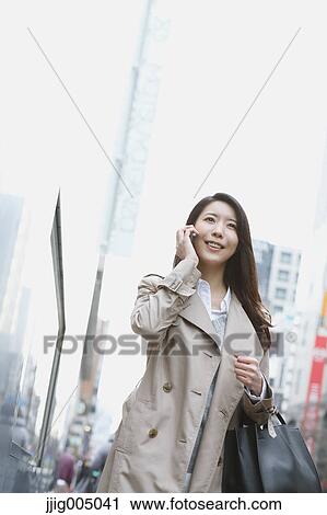 Young attractive Japanese woman downtown Tokyo View Large Photo Image Stock Image - Young attractive Japanese woman downtown Tokyo. Fotosearch