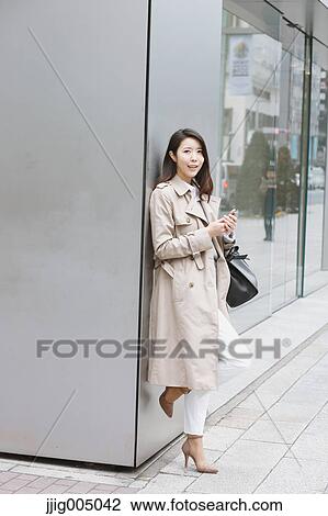 Young attractive Japanese woman downtown Tokyo View Large Photo Image Stock Image - Young attractive Japanese woman downtown Tokyo. Fotosearch