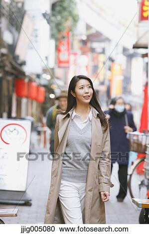 Stock Image - Young attractive Japanese woman downtown Tokyo. Fotosearch