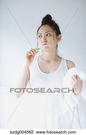 Young attractive Japanese woman brushing teeth in the bathroom View Large Photo Image Stock Image - Young attractive Japanese woman brushing teeth in the bathroom. Fotosearch