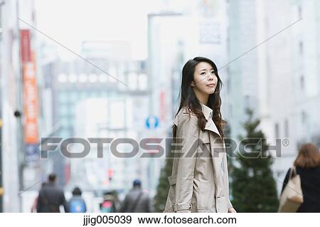 Young attractive Japanese woman downtown Tokyo View Large Photo Image Stock Photo - Young attractive Japanese woman downtown Tokyo. Fotosearch