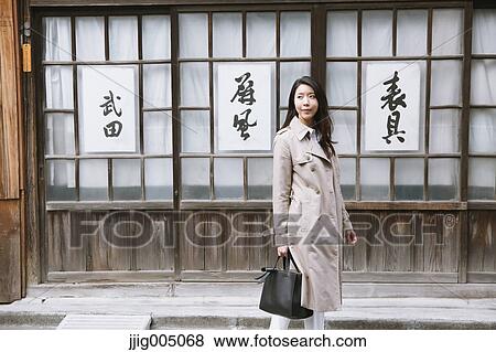 Stock Photo - Young attractive Japanese woman downtown Tokyo. Fotosearch
