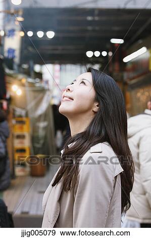 Stock Photo - Young attractive Japanese woman downtown Tokyo. Fotosearch