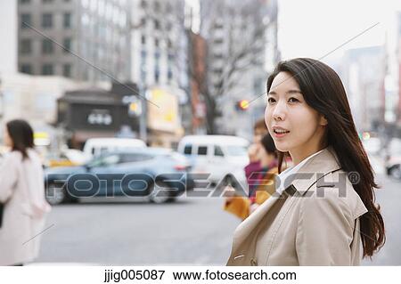 Stock Photo - Young attractive Japanese woman downtown Tokyo. Fotosearch
