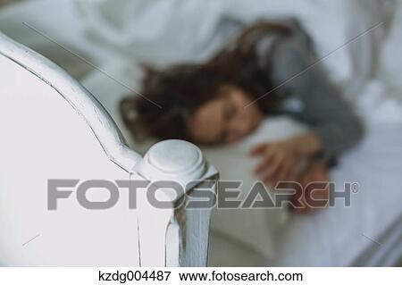 Stock Photo - Young attractive Japanese woman sleeping in bed. Fotosearch