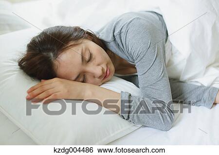 Young attractive Japanese woman sleeping in bed View Large Photo Image Stock Photograph - Young attractive Japanese woman sleeping in bed. Fotosearch