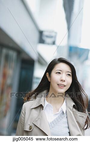 Stock Photography - Young attractive Japanese woman downtown Tokyo. Fotosearch
