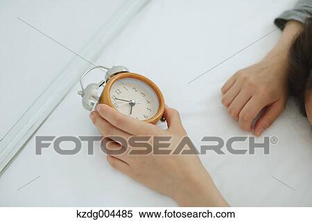 Stock Photography - Young attractive Japanese woman sleeping in bed. Fotosearch
