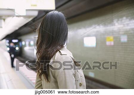 Young attractive Japanese woman waiting for the train View Large Photo Image Stock Image - Young attractive Japanese woman waiting for the train. Fotosearch