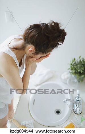 Young attractive Japanese woman washing face in the bathroom View Large Photo Image Picture - Young attractive Japanese woman washing face in the bathroom. Fotosearch