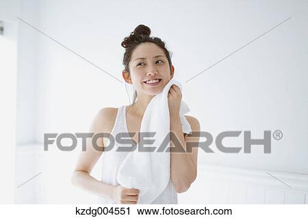 Young attractive Japanese woman wiping face with towel in the bathroom View Large Photo Image Stock Image - Young attractive Japanese woman wiping face with towel in the bathroom. Fotosearch