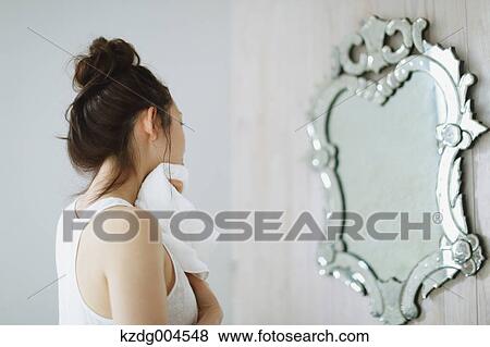 Young attractive Japanese woman wiping face with towel in the bathroom View Large Photo Image Stock Photo - Young attractive Japanese woman wiping face with towel in the bathroom. Fotosearch