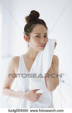 Young attractive Japanese woman wiping face with towel in the bathroom View Large Photo Image Stock Photography - Young attractive Japanese woman wiping face with towel in the bathroom. Fotosearch