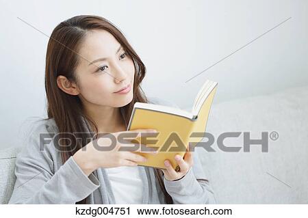 Young attractive Japanese woman with book on the sofa View Large Photo Image Stock Image - Young attractive Japanese woman with book on the sofa. Fotosearch