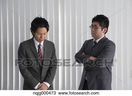 Young Japanese businessman being scored by his boss View Large Photo Image Stock Image - Young Japanese businessman being scored by his boss. Fotosearch