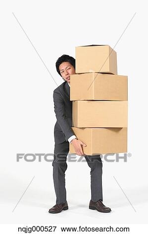 Young Japanese businessman carrying boxes View Large Photo Image Stock Photo - Young Japanese businessman carrying boxes. Fotosearch