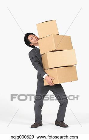 Young Japanese businessman carrying boxes View Large Photo Image Stock Photo - Young Japanese businessman carrying boxes. Fotosearch