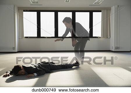 Young Japanese businessman dead on the floor of an empty office View Large Photo Image Stock Photo - Young Japanese businessman dead on the floor of an empty office. Fotosearch