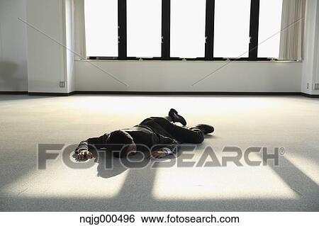 Young Japanese businessman dead on the floor of an empty office View Large Photo Image Stock Photograph - Young Japanese businessman dead on the floor of an empty office. Fotosearch