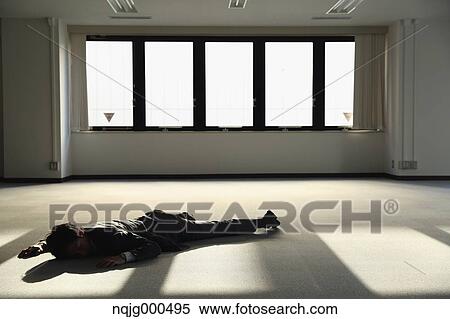 Young Japanese businessman dead on the floor of an empty office View Large Photo Image Stock Photography - Young Japanese businessman dead on the floor of an empty office. Fotosearch