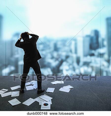 Young Japanese businessman with lots of scattered documents View Large Photo Image Stock Photo - Young Japanese businessman with lots of scattered documents. Fotosearch