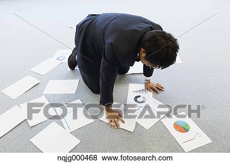 Young Japanese businessman with lots of scattered documents View Large Photo Image Stock Photo - Young Japanese businessman with lots of scattered documents. Fotosearch