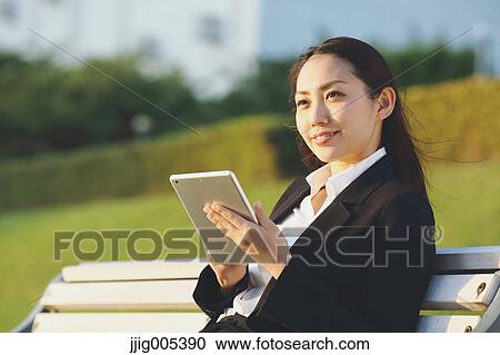 Young Japanese businesswoman with tablet by a river downtown Tokyo View Large Photo Image Stock Image - Young Japanese businesswoman with tablet by a river downtown Tokyo. Fotosearch