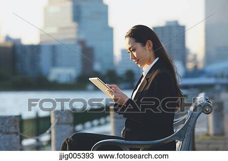 Young Japanese businesswoman with tablet by a river downtown Tokyo View Large Photo Image Stock Image - Young Japanese businesswoman with tablet by a river downtown Tokyo. Fotosearch
