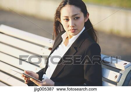 Young Japanese businesswoman with tablet by a river downtown Tokyo View Large Photo Image Stock Photo - Young Japanese businesswoman with tablet by a river downtown Tokyo. Fotosearch