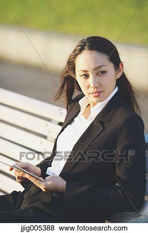 Young Japanese businesswoman with tablet by a river downtown Tokyo View Large Photo Image Stock Photo - Young Japanese businesswoman with tablet by a river downtown Tokyo. Fotosearch