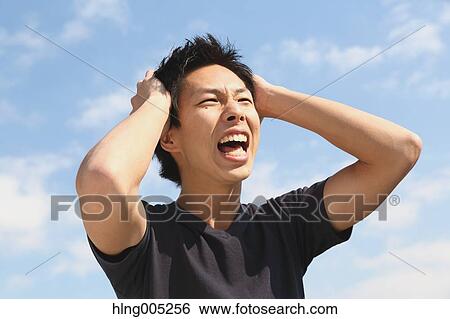 Young Japanese man cheering against blue sky View Large Photo Image Stock Photograph - Young Japanese man cheering against blue sky. Fotosearch