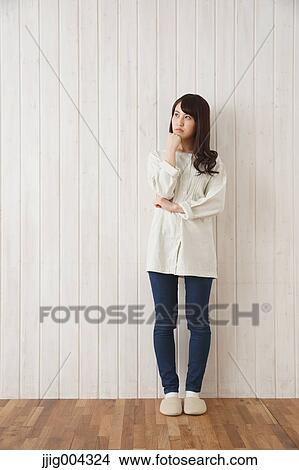 Young Japanese woman against wooden wall View Large Photo Image Picture - Young Japanese woman against wooden wall. Fotosearch