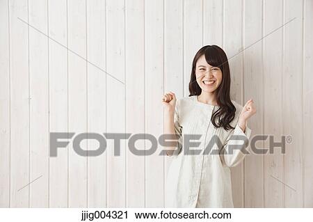 Young Japanese woman against wooden wall View Large Photo Image Stock Image - Young Japanese woman against wooden wall. Fotosearch