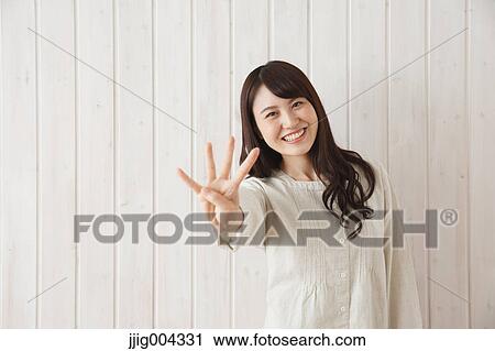Young Japanese woman against wooden wall View Large Photo Image Stock Image - Young Japanese woman against wooden wall. Fotosearch