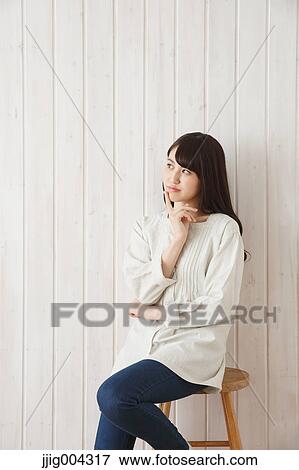 Young Japanese woman against wooden wall View Large Photo Image Stock Photo - Young Japanese woman against wooden wall. Fotosearch