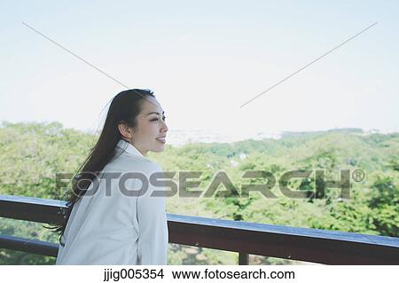 Young Japanese woman at observation deck in a city park View Large Photo Image Picture - Young Japanese woman at observation deck in a city park. Fotosearch
