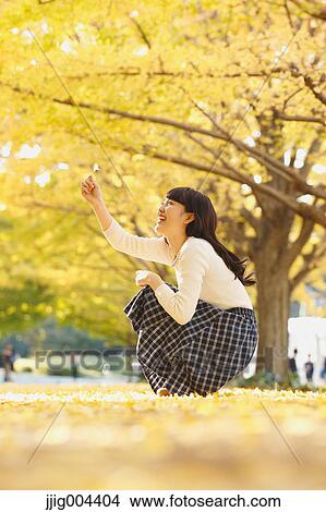 Young Japanese woman in a city park View Large Photo Image Picture - Young Japanese woman in a city park. Fotosearch