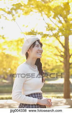 Young Japanese woman in a city park View Large Photo Image Stock Photo - Young Japanese woman in a city park. Fotosearch