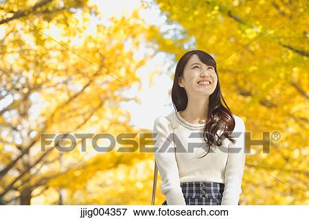 Young Japanese woman in a city park View Large Photo Image Stock Photo - Young Japanese woman in a city park. Fotosearch